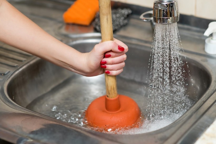 how to unclog a garbage disposal with a plunger